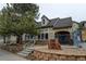 Exterior shot of the Deer Creek Clubhouse with landscaping, stone signage, and architectural details at 8369 S Independence Cir # 205, Littleton, CO 80128