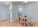 Bright dining area with light wood floors, a modern table, and a view of the entryway at 8369 S Independence Cir # 205, Littleton, CO 80128
