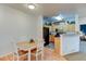 Open dining area with a view into the kitchen and another room, featuring a wooden table at 8369 S Independence Cir # 205, Littleton, CO 80128