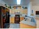 Updated kitchen features wood cabinets, granite countertops, and black appliances at 8369 S Independence Cir # 205, Littleton, CO 80128