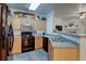 Updated kitchen offers wood cabinets, laminate countertops and black appliances at 8369 S Independence Cir # 205, Littleton, CO 80128
