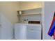 Laundry room features a full-size washer and dryer with storage space at 8369 S Independence Cir # 205, Littleton, CO 80128