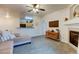 Inviting living room showcasing a fireplace, ceiling fan, and a view into the kitchen area at 8369 S Independence Cir # 205, Littleton, CO 80128