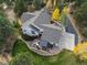 Aerial view of a landscaped property featuring a well-maintained house, deck and mature trees at 740 W Lancers Ct, Monument, CO 80132