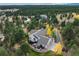 Sprawling property showcasing lush surroundings, mature trees, and expansive outdoor patio at 740 W Lancers Ct, Monument, CO 80132