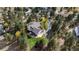 Stunning aerial view of a home with a deck and landscaped yard nestled among lush trees in a serene neighborhood at 740 W Lancers Ct, Monument, CO 80132
