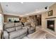 Finished basement featuring a cozy seating area, fireplace, bar area, and staircase to the main level at 740 W Lancers Ct, Monument, CO 80132