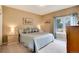 Comfortable bedroom with a bed with light blue coverings, two bedside tables and a window with blue curtains at 740 W Lancers Ct, Monument, CO 80132
