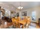 Open dining room with hardwood floors, chandelier, and a view into the kitchen at 740 W Lancers Ct, Monument, CO 80132