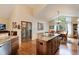 Bright dining room with hardwood floors, island, and large window overlooking a wooded area at 740 W Lancers Ct, Monument, CO 80132