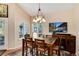 Cozy dining room with stylish chandelier, a wall mounted TV, and backyard views at 740 W Lancers Ct, Monument, CO 80132