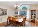 Dining room with large windows, chandelier, hardwood floors, and decorative rug at 740 W Lancers Ct, Monument, CO 80132