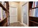 Charming hallway featuring a wine cellar door, built-in bookshelves, and tile flooring at 740 W Lancers Ct, Monument, CO 80132