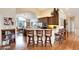 Open-concept kitchen with island seating, stainless steel appliances, and adjacent dining area at 740 W Lancers Ct, Monument, CO 80132