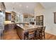 Open kitchen with large island, stainless steel appliances, granite counters, and wood floors at 740 W Lancers Ct, Monument, CO 80132
