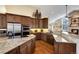 Spacious kitchen featuring stainless steel appliances, granite countertops, and rich wood cabinetry at 740 W Lancers Ct, Monument, CO 80132