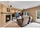 Inviting living room with cozy fireplace, comfortable seating, a large screen TV and a walkout door at 740 W Lancers Ct, Monument, CO 80132