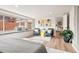 Bright bedroom featuring a window seat, two chairs, and light hardwood floors at 4165 Ingalls St, Wheat Ridge, CO 80033