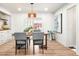 A dining room with an oval table and gray upholstered chairs underneath a modern chandelier at 4165 Ingalls St, Wheat Ridge, CO 80033