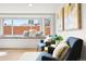 A sun-filled living room featuring cozy seating arrangements and a bright bay window at 4165 Ingalls St, Wheat Ridge, CO 80033