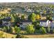 Picturesque aerial view of a neighborhood with lush greenery and rolling hills in the background at 10039 Heatherwood Pl, Highlands Ranch, CO 80126