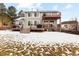 View of the back of the house with a large back yard, multi level patio, and stairs at 10039 Heatherwood Pl, Highlands Ranch, CO 80126