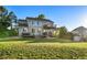 Expansive backyard featuring a two-level deck, mature lawn, and serene landscaping at 10039 Heatherwood Pl, Highlands Ranch, CO 80126