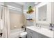 Neutral bathroom featuring a tub and shower, updated vanity and fixtures, and decorative shelving at 10039 Heatherwood Pl, Highlands Ranch, CO 80126