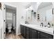 Stylish bathroom features modern wallpaper, double sinks, and gold accents at 10039 Heatherwood Pl, Highlands Ranch, CO 80126