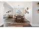 Elegant dining room with a long wooden table, seating for ten, and stylish decor at 10039 Heatherwood Pl, Highlands Ranch, CO 80126
