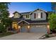 Charming two-story home with a brick facade, two-car garage, and manicured front yard at 10039 Heatherwood Pl, Highlands Ranch, CO 80126