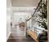Inviting foyer with wood floors, arched doorway and staircase with bench seating at 10039 Heatherwood Pl, Highlands Ranch, CO 80126