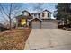 Charming two-story home with a brick facade, three-car garage, and well-maintained front yard at 10039 Heatherwood Pl, Highlands Ranch, CO 80126