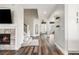 Inviting hallway with wood floors, a fireplace, and an arched doorway to another room at 10039 Heatherwood Pl, Highlands Ranch, CO 80126