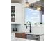 Bright kitchen featuring white cabinets, arabesque backsplash and copper sink beneath a garden window at 10039 Heatherwood Pl, Highlands Ranch, CO 80126
