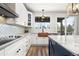 Bright kitchen features white cabinets, a copper sink, a large island and stainless steel appliances at 10039 Heatherwood Pl, Highlands Ranch, CO 80126