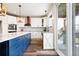 Bright kitchen featuring a large island, white cabinetry, and stainless steel appliances at 10039 Heatherwood Pl, Highlands Ranch, CO 80126