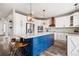 Modern kitchen featuring a large center island with bar stool seating and pendant lighting at 10039 Heatherwood Pl, Highlands Ranch, CO 80126