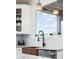 Close up of modern kitchen sink area with patterned backsplash and cabinetry at 10039 Heatherwood Pl, Highlands Ranch, CO 80126