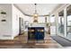 Bright kitchen boasts a stylish island with seating, modern pendant lights, and stainless steel appliances at 10039 Heatherwood Pl, Highlands Ranch, CO 80126