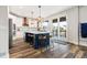 Bright kitchen boasts a stylish island with seating, modern pendant lights, and stainless steel appliances at 10039 Heatherwood Pl, Highlands Ranch, CO 80126