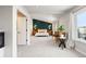 Spacious bedroom boasts a decorative accent wall, neutral tones, and bright, natural light at 10039 Heatherwood Pl, Highlands Ranch, CO 80126