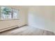 Bright, empty bedroom with hardwood floors and a large window at 1117 Elysian Field Dr # A, Lafayette, CO 80026