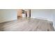Open concept living space with light gray wood floors, neutral paint and a view of the kitchen at 1117 Elysian Field Dr # A, Lafayette, CO 80026