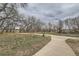 Scenic walking path winding through the neighborhood, with lush greenery and mature trees at 1117 Elysian Field Dr # A, Lafayette, CO 80026