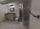 Bathroom featuring a vanity with granite counters and a glass enclosed shower, a modern look at 8543 Redstone St, Highlands Ranch, CO 80126