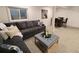 Relaxing basement living area featuring a comfortable couch, a stylish coffee table, and a dining area for entertaining at 8543 Redstone St, Highlands Ranch, CO 80126