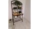 Bathroom baker's rack displays decorative hand towels, floral arrangements, and personal hygiene products at 8543 Redstone St, Highlands Ranch, CO 80126