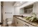 Bathroom featuring granite countertops, decorative mirror, and toilet at 8543 Redstone St, Highlands Ranch, CO 80126
