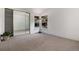 Bedroom featuring carpet, mirrored closet doors, and outdoor views at 8543 Redstone St, Highlands Ranch, CO 80126